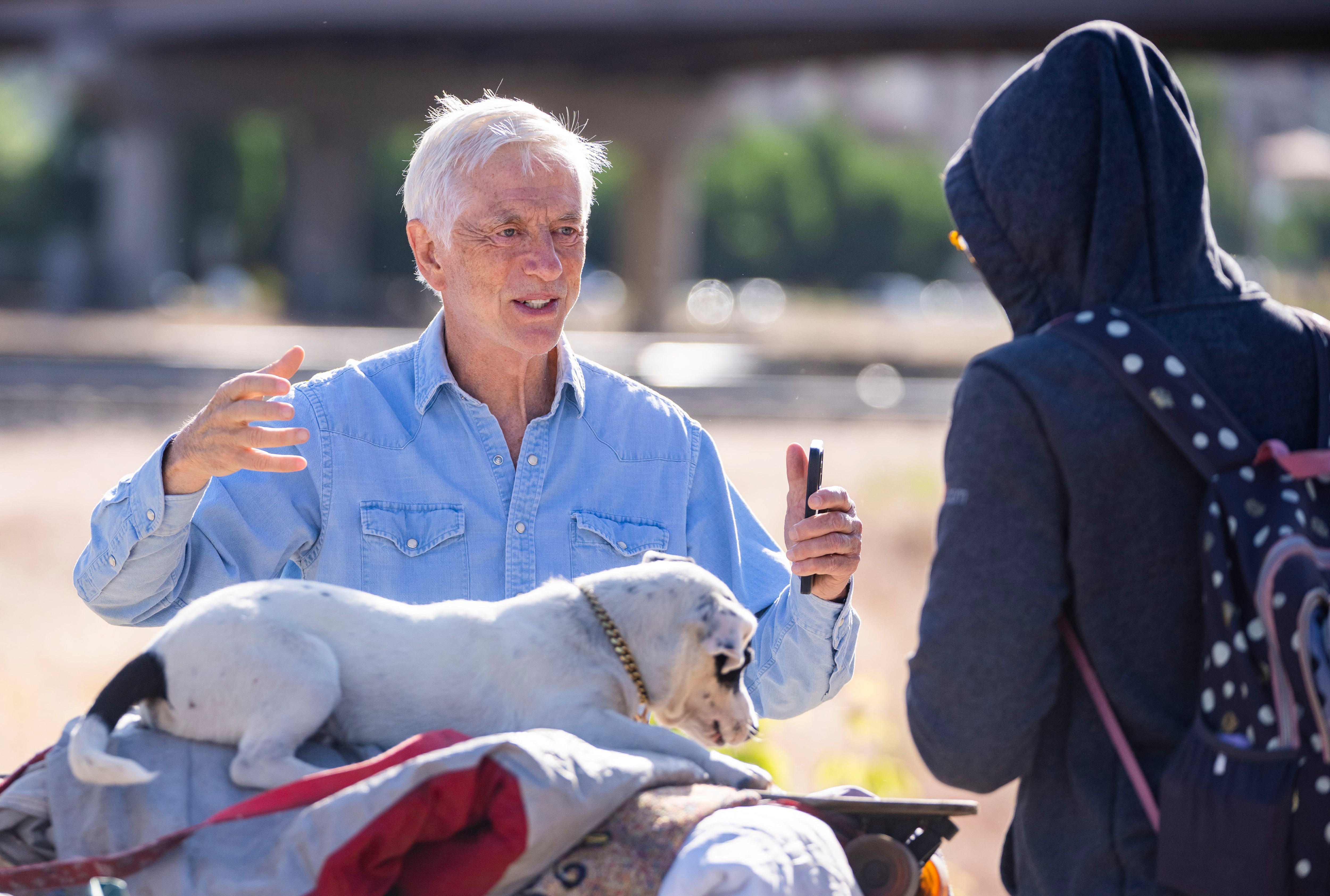(Rick Egan | The Salt Lake Tribune) Former Mayor Rocky Anderson talks to a woman experiencing homelessness near the railroad tracks on 800 East, Thursday, June 8, 2023. He says the city needs to set up a much-larger camp for unsheltered Utahns.
