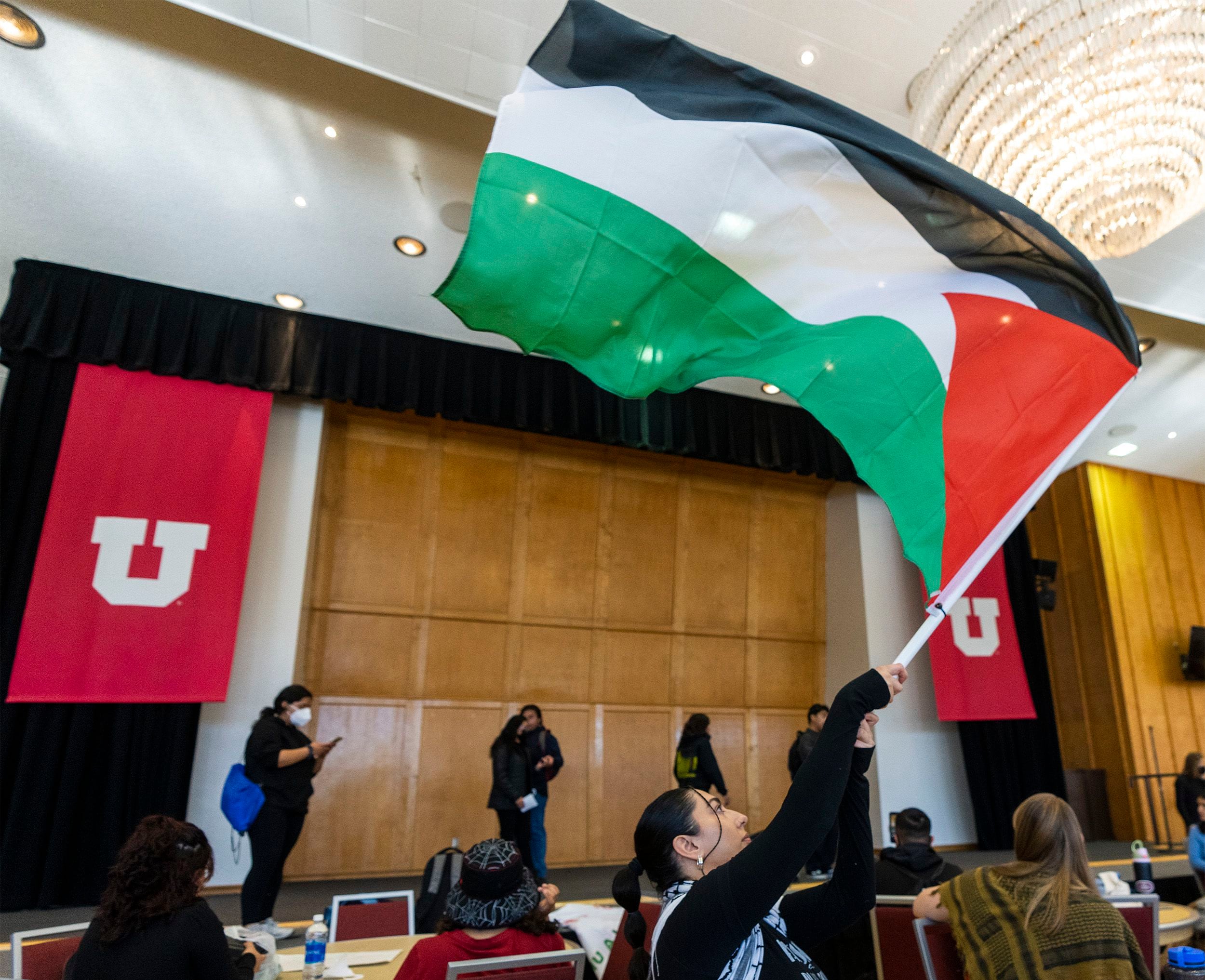 (Rick Egan | The Salt Lake Tribune) Palestinian student Muna Omar waves a flag during a sit-in, as the group Mecha occupies the Union Ballroom during a protest on the University of Utah Campus, on Wednesday, Nov. 15, 2023.
