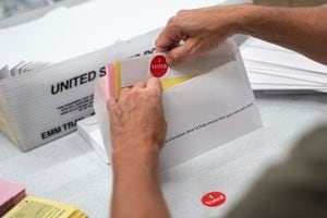 (Glen Stubbe | Star Tribune via AP) In this July 29, 2020, file photo, Todd Gallagher prepares mail-in ballot envelopes including an I Voted sticker in Minneapolis. Utah County voters will decide on Nov. 3 whether to retain their three-member county commission form of government or switch to a mayor-council system.
