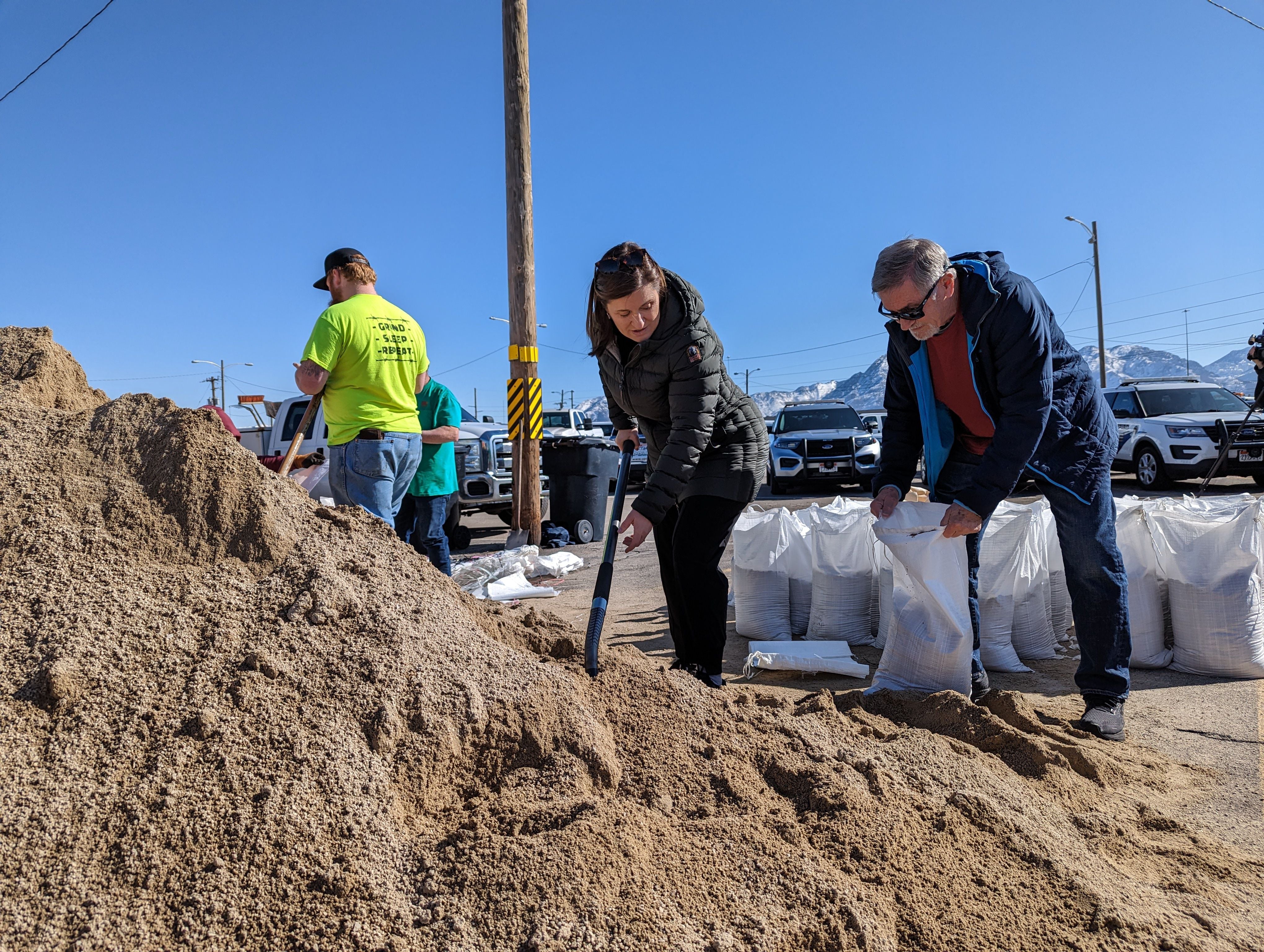(Blake Apgar | The Salt Lake Tribune) Salt Lake County Mayor Jenny Wilson fills sandbags with her father, former Salt Lake City Mayor Ted Wilson, in Midvale on Friday, March 17, 2023. The county is preparing for potential flooding during runoff season in the Wasatch Mountains.