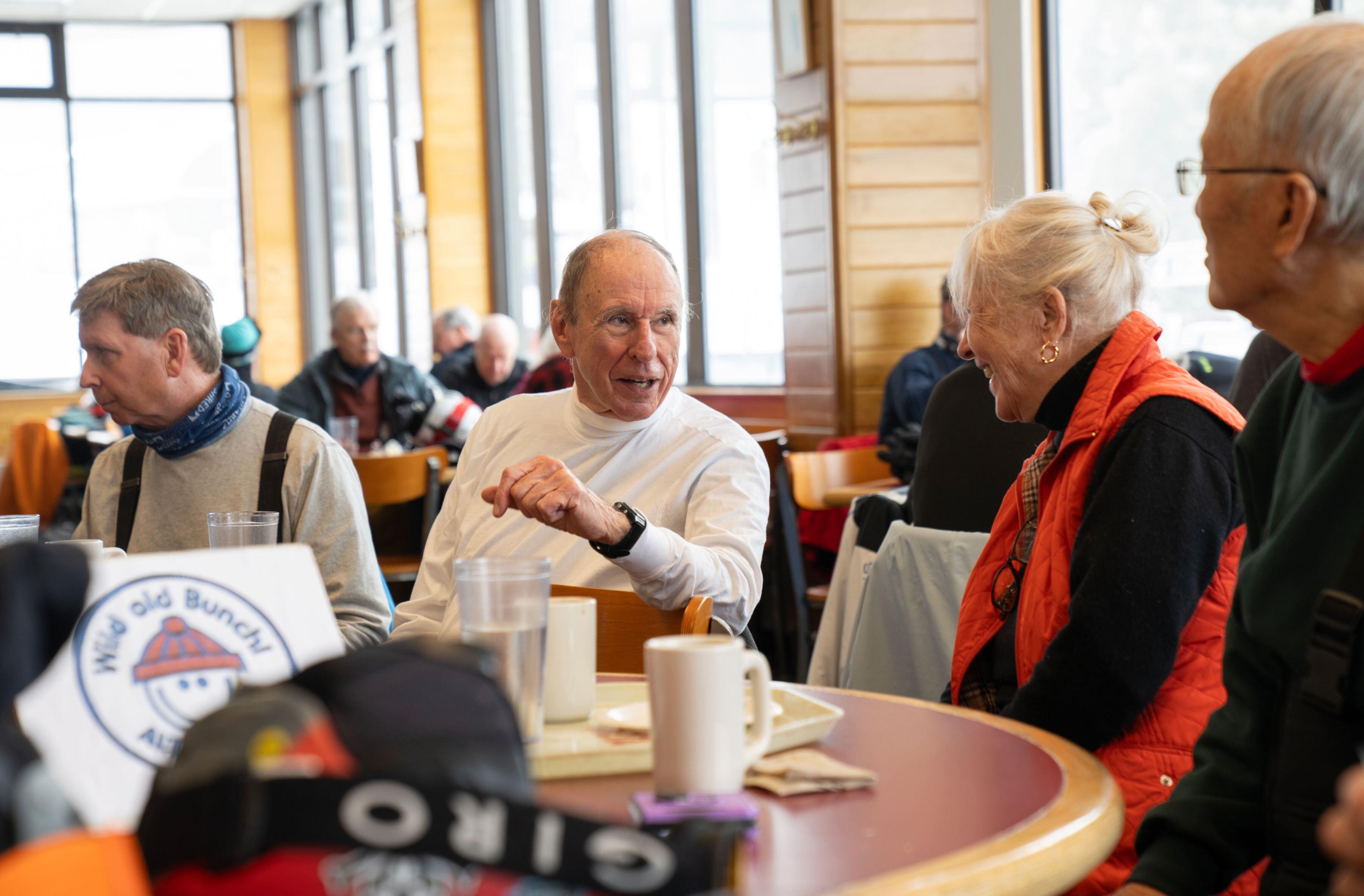 Wild old Bunch members, from left: Leo Exley, Bob Phiilips, Classie Page and Hugh Paik at Alf’s Restaurant after morning runs at the Alta Ski Area, in Alta, Utah, March 13, 2024. The Wild old Bunch (who meaningfully chose to lowercase “old” in the name), a ski club for seniors that started in 1973 and boasts around 115 members, has 80- and 90-year-olds that still ski. (Kate Russell/The New York Times)