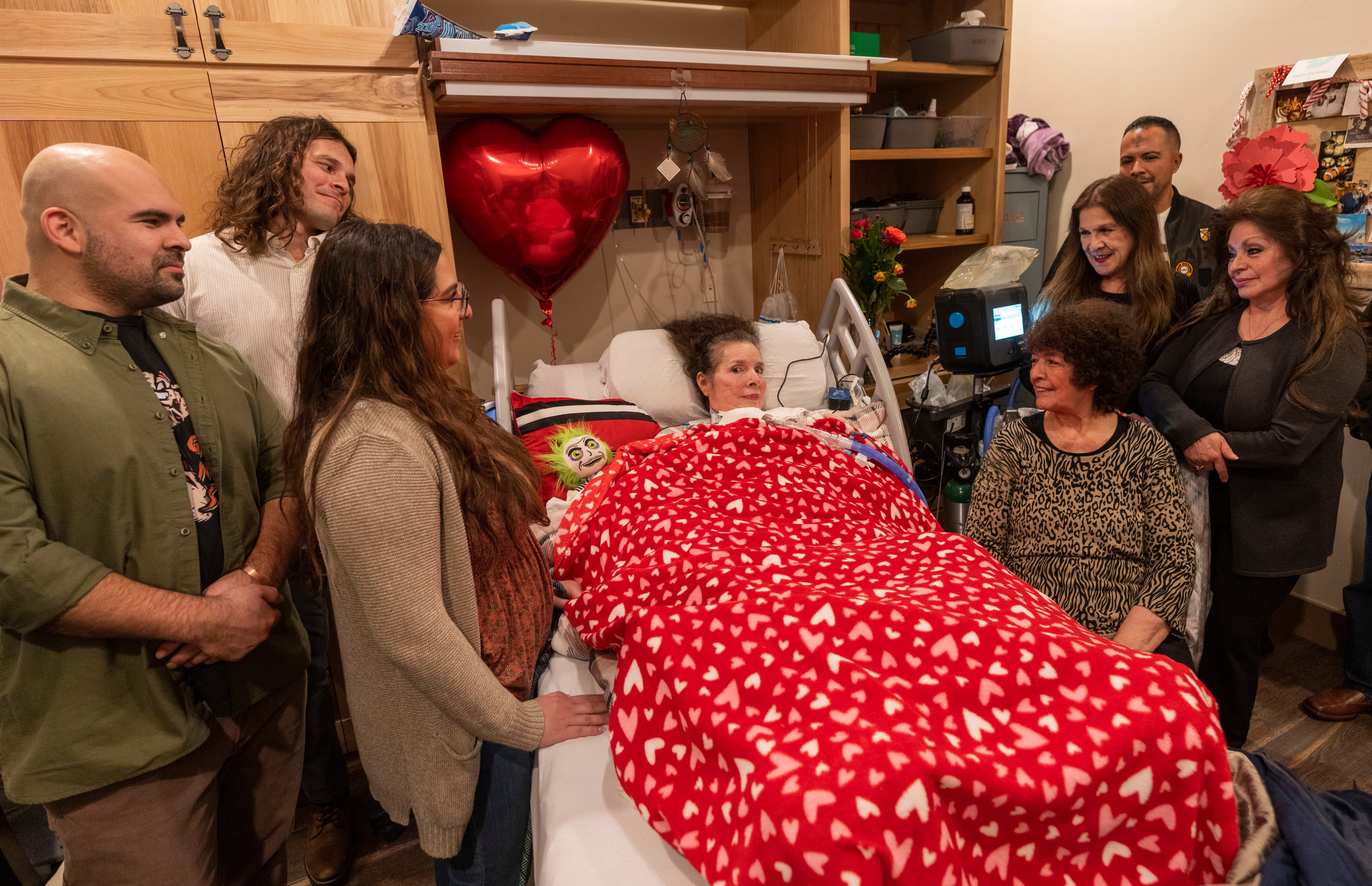 (Rick Egan | The Salt Lake Tribune) Relatives gather to celebrate Valentines Day with Patricia Gallegos Delgado, in her room at NeuroRestorative in Riverton, on Wednesday, Feb. 14, 2024.
