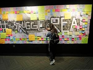 (Rick Bowmer | AP photo)

In this Nov. 14, 2019, photo, a student attaches a note to the Resilience Project board on the campus of Utah Valley University, in Orem, Utah. The purpose of the project is to let students know that it is OK to struggle.