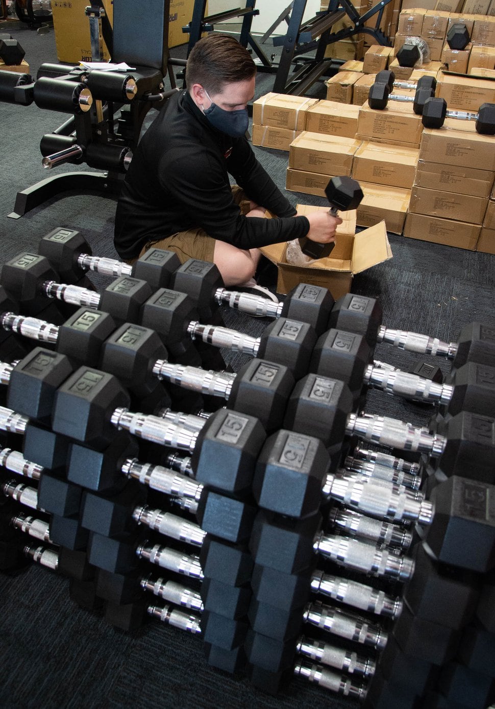 (Francisco Kjolseth | The Salt Lake Tribune) Chase Buckles, sales manager at Utah Home Fitness in Sandy, takes advantage of a slow moment to catch up on restocking inventory on Wednesday, Oct. 22, 2020. 