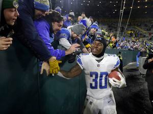 (Mike Roemer | AP) Detroit Lions running back Jamaal Williams celebrates with fans following an NFL football game against the Green Bay Packers Sunday, Jan. 8, 2023, in Green Bay, Wis. The Lions won 20-16.