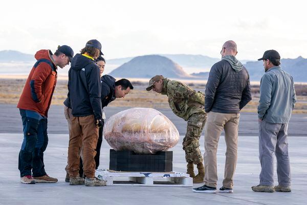 (Rick Egan | The Salt Lake Tribune)  Workers from Varda Space Industries check out the capsule at the Wendover Airport after it landed in the West Desert on Wednesday, Feb. 21, 2024.