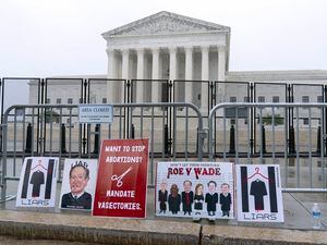 (Jose Luis Magana | AP) Signs placed at the fence outside of the U.S. Supreme Court on Capitol Hill in Washington, Thursday, June 23, 2022.