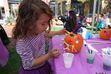 (The Gateway) A girl decorates a jack-o-lantern at the 2018 Pumpkin Festival at The Gateway. The 2022 edition is set for Oct. 22, at The Gateway's Olympic Legacy Fountain, at 50 S. Rio Grande St., Salt Lake City.