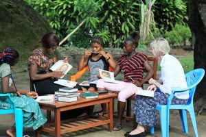 (Photo courtesy of The Church of Jesus Christ of Latter-day Saints)
Jean B. Bingham, Relief Society general president, studies Gospel Literacy program materials with a group of women in Sierra Leone, June 2019. A researcher has discovered that Latter-day Saint women in the global faith enjoy stronger families, thanks to the church's teachings and practices.