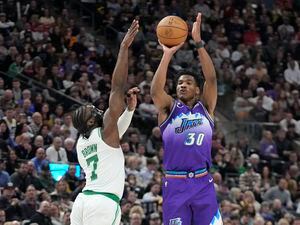 Utah Jazz guard Ochai Agbaji (30) shoots as Boston Celtics guard Jaylen Brown (7) defends during the second half of an NBA basketball game, Saturday, March 18, 2023, in Salt Lake City. (AP Photo/Rick Bowmer)