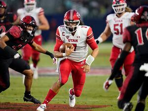 (Ashley Landis | AP) Utah quarterback Cameron Rising (7) runs the ball during the second half of an NCAA college football game against San Diego State Saturday, Sept. 18, 2021, in Carson, Calif.