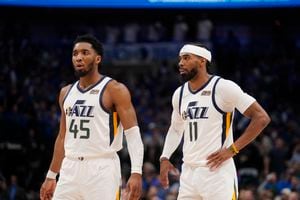 Utah Jazz guard Donovan Mitchell (45) and guard Mike Conley (11) stand on the court during the second half of Game 5 of an NBA basketball first-round playoff series against the Dallas Mavericks, Monday, April 25, 2022, in Dallas. (AP Photo/Tony Gutierrez)