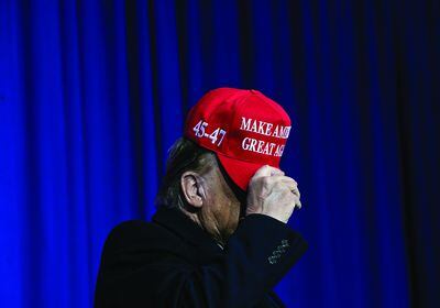 (Emily Elconin | The New York Times) Former President Donald Trump tips his hat to the crowd at a campaign rally in Waterford, Mich., Feb. 17, 2024.