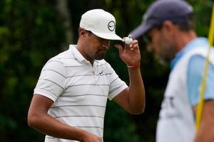 (Carlos Osorio | AP) Tony Finau acknowledges fans after his birdie putt on the eighth green during the first round of the Rocket Mortgage Classic golf tournament, Thursday, July 28, 2022, in Detroit.