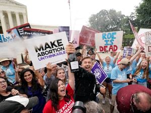 (Steve Helber | AP) A celebration outside the Supreme Court, Friday, June 24, 2022, in Washington. The Supreme Court has ended constitutional protections for abortion that had been in place nearly 50 years — a decision by its conservative majority to overturn the court's landmark abortion cases.