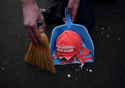 (Kenny Holston | The New York Times)

A broken decorative MAGA hat is swept up during a demonstration against Donald Trump on Election Day in Washington, Nov. 3, 2020.