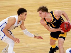 UC Irvine's Dawson Baker keeps the ball from UC Santa Barbara's Jaquori McLaughlin (3) during the first half of an NCAA college basketball game for the championship of the Big West Conference men's tournament Saturday, March 13, 2021, in Las Vegas. (AP Photo/Ronda Churchill)