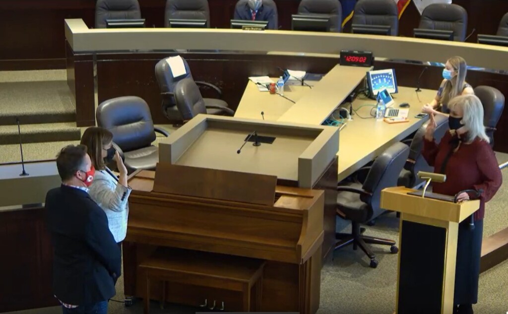 (Screenshot courtesy Salt Lake County) Salt Lake County Clerk Sherrie Swensen, right, swears in Mayor Jenny Wilson while Wilson's husband Trell Rohovit looks on during a socially distanced inauguration ceremony on Monday, Jan. 4, 2021.