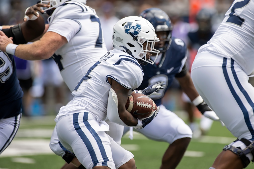 (Tyler Tate | AP) Utah State Aggies running back Calvin Tyler Jr. (4) runs the football during an NCAA football game on Saturday, August, 27, 2022 in Logan.
