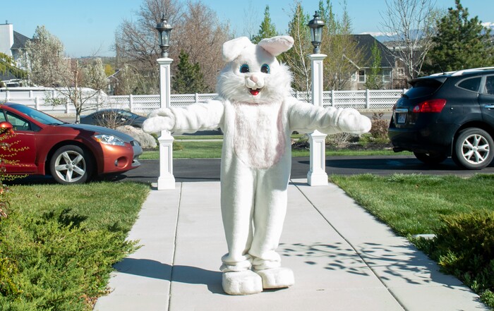 (Rick Egan  |  The Salt Lake Tribune)     Makea Kelly dressed as the Easter Bunny, waves at children as they come to the door to get their Easter Eggs, as she she assists Draper City Parks and Recreation workers, the police and the fire department, as they deliver more than 30,000 Easter eggs to children at their doorsteps in Draper, Friday, April 10.