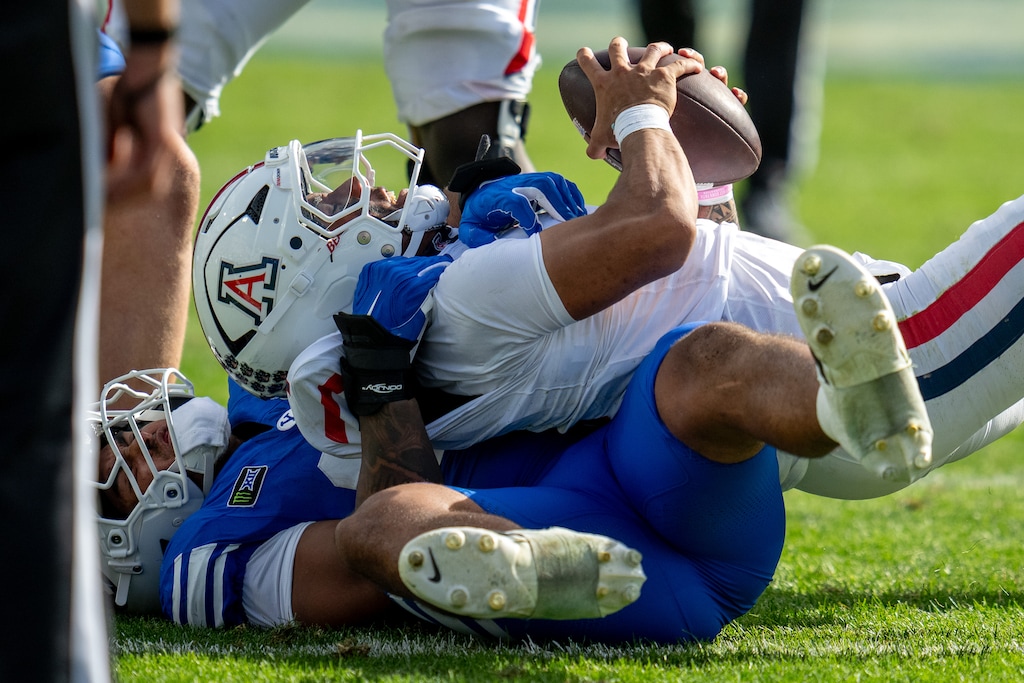 (Trent Nelson  |  The Salt Lake Tribune) BYU Cougars defensive lineman Tausili Akana (13) sacks Arizona Wildcats quarterback Noah Fifita (1) as BYU hosts Arizona, NCAA football in Provo on Saturday, Sept. 12, 2026.