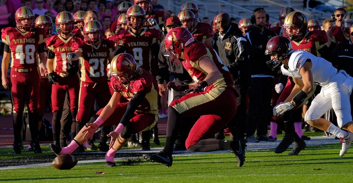 (Leah Hogsten  |  The Salt Lake Tribune) Viewmont's Chris Stubbs picks up a fumble. Jordan High School boys' football team defeated Viewmont High School 28-20 during their class 5A football playoff opener, Friday, October 27, 2017 in Bountiful.