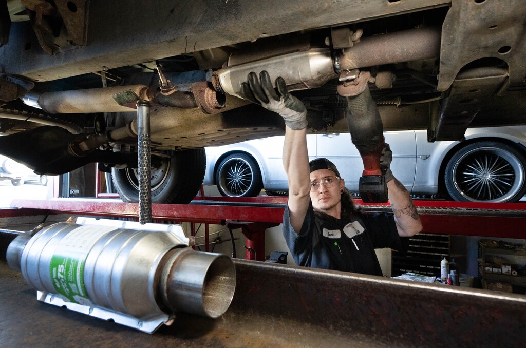 (Francisco Kjolseth | The Salt Lake Tribune) Sam Howard, assistant manager at Master Muffler in Murray replaces a worn out catalytic converter on a vehicle on Thursday, Jan. 20, 2022. Catalytic converter thefts are spiking in Utah, and some legislation is being considered to help track stolen converters.