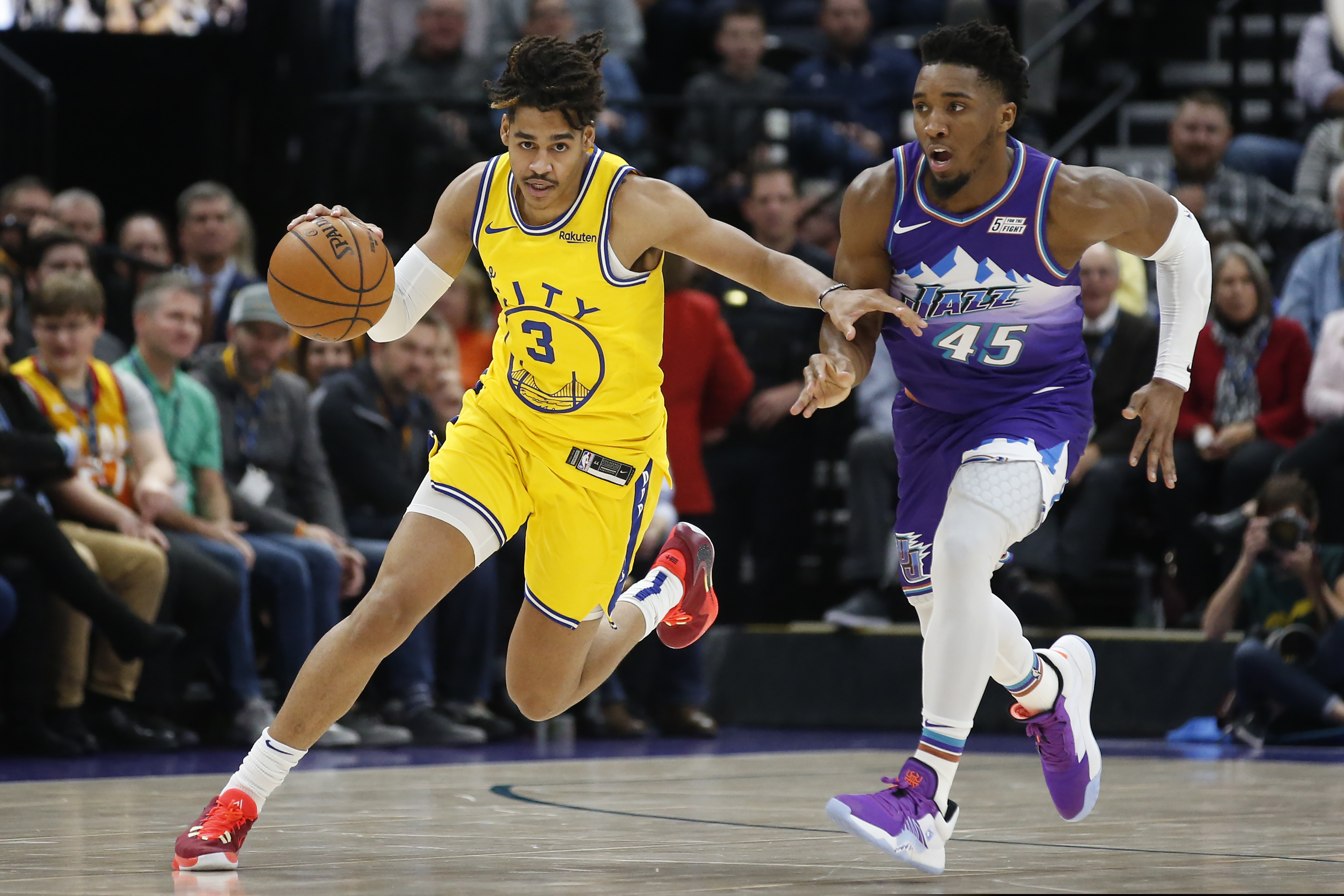 Golden State Warriors guard Jordan Poole (3) brings the ball ups court as Utah Jazz guard Donovan Mitchell (45) defends in the first half during an NBA basketball game Friday, Nov. 22, 2019, in Salt Lake City. (AP Photo/Rick Bowmer)