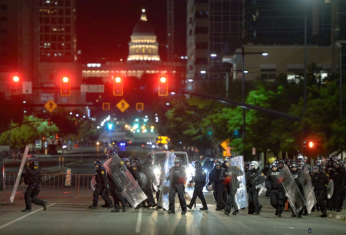 (Francisco Kjolseth  |  The Salt Lake Tribune) Police with shields fill the north bound lane of State street and push people south as they enforce a mandatory curfew in Salt Lake City on Monday, June 1, 2020, following violence and unrest over the weekend due to the death of George Floyd by police.