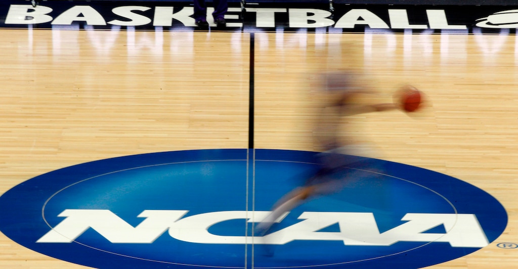FILE - In this March 14, 2012, file photo, a player runs across the NCAA logo during practice at the NCAA tournament college basketball in Pittsburgh. The NCAA Board of Governors took the first step Tuesday, Oct. 29, 2019, toward allowing athletes to cash in on their fame, voting unanimously to clear the way for the amateur athletes to "benefit from the use of their name, image and likeness."
(AP Photo/Keith Srakocic, File)