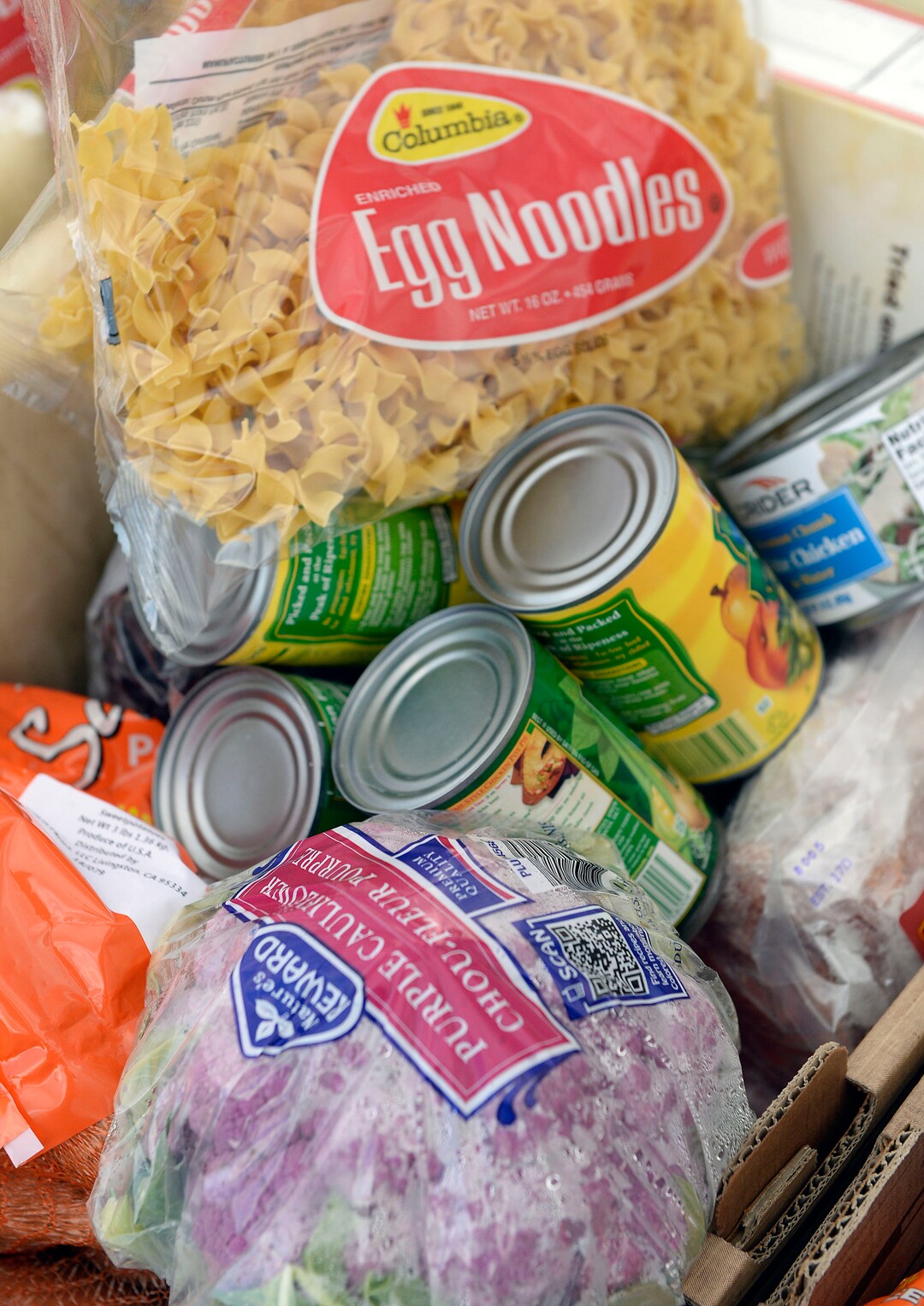 (Al Hartmann  |  The Salt Lake Tribune) 	Volunteers of the Utah Food Bank pack food boxes in the parking lot of the LDS Church at 1860 S. 300 E. in Salt Lake City Friday April 13. Each box has a variety of canned food, fresh vegetables and other staples. It's one of 18 locations the bank operates to get food out to the food insecure.  An army of volunteers make the distrbution system work. Walmart, Feeding America and Utah Food Bank are teaming up during the month of April to fight hunger through an online and in-store donation campaign.