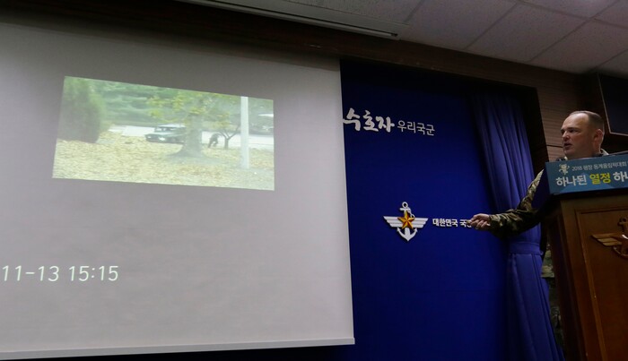 Col. Chad G. Carroll, a spokesman for the U.N. command, shows the CCTV footage regarding a North Korean soldier's defection during a press conference at the Defense Ministry in Seoul, South Korea, Wednesday, Nov. 22, 2017. A North Korean soldier made a desperate dash to freedom in a jeep and then on foot, being shot at least five times as he limped across the border and was rescued by South Korean soldiers, according to dramatic video released by the U.S.-led U.N. command Wednesday. (AP Photo/Ahn Young-joon)