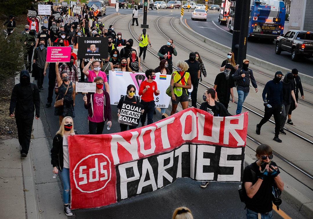 (Trent Nelson  |  The Salt Lake Tribune) Protesters march as Vice President Mike Pence and Sen. Kamala Harris prepare to debate at Kingsbury Hall in Salt Lake City on Wednesday, Oct. 7, 2020.
