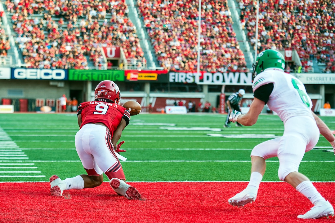 (Chris Detrick  |  The Salt Lake Tribune)  Utah Utes wide receiver Darren Carrington (9) makes a touchdown catch past North Dakota Fighting Hawks defensive back Evan Holm (6) during the game at Rice-Eccles Stadium Thursday, August 31, 2017. Utah Utes are leading North Dakota Fighting Hawks 17-9 at halftime. 