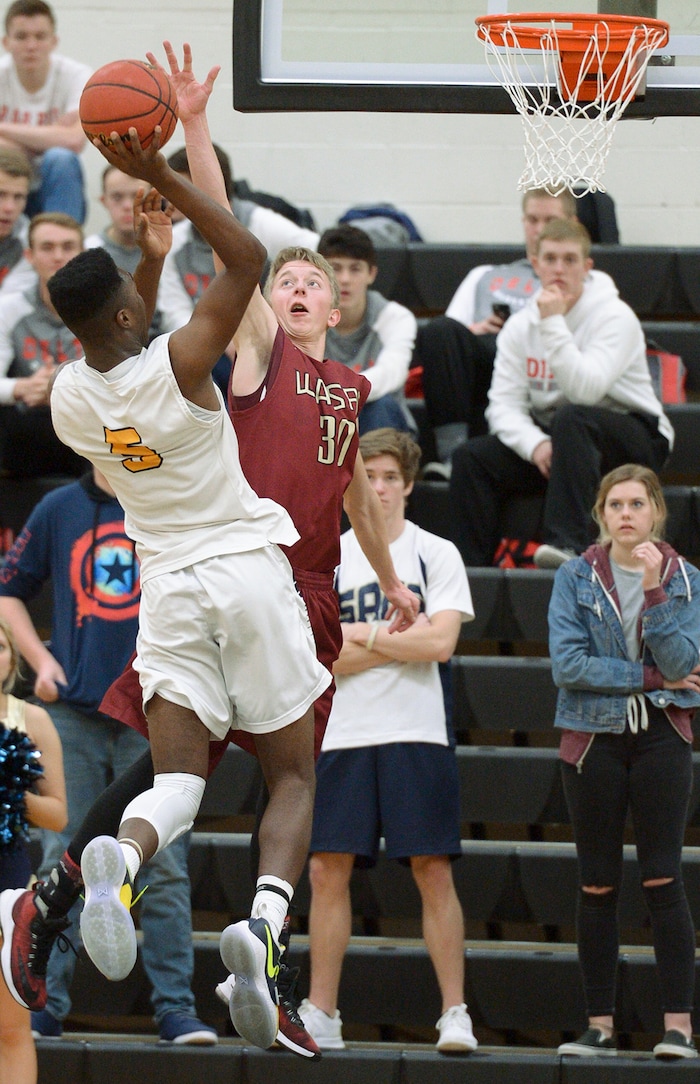 (Leah Hogsten  |  The Salt Lake Tribune) Juab's Kollin Robertson tries to stop Summit's Jalexus Gilson. Juab High School boys' basketball team defeated Summit Academy 61-58 during their 3A State tournament game in Heber  Saturday, Feb. 16, 2018.