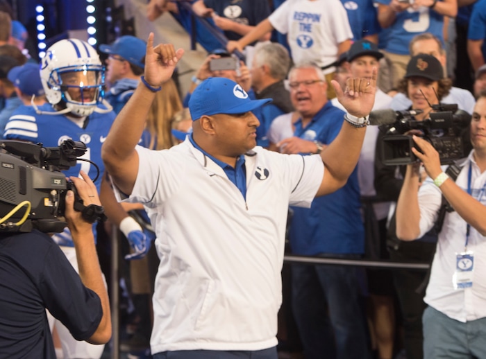 (Rick Egan  |  The Salt Lake Tribune)  Brigham Young Cougars head coach Kalani Satike gets the crowd going as he enters the field before the big game at Lavell Edwards Stadium in Provo, Saturday, September 9, 2017.