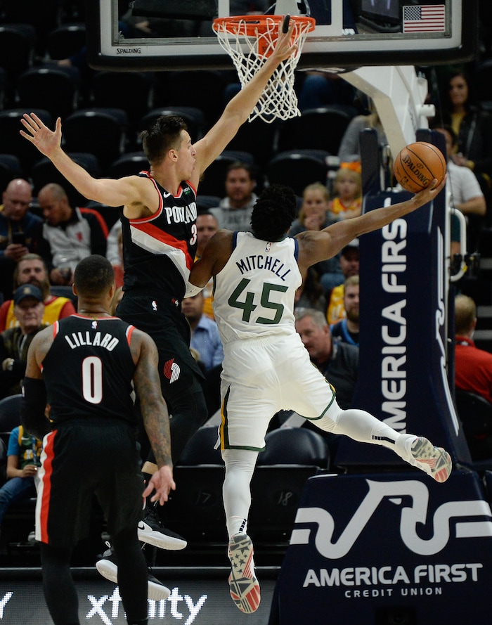 (Francisco Kjolseth  |  The Salt Lake Tribune)  Portland Trail Blazers forward Zach Collins (33) puts the pressure on Utah Jazz guard Donovan Mitchell (45) as the Utah Jazz host the Portland Trailblazers in their NBA basketball game at Vivint Smart Home Arena in Salt Lake City on Wed. Oct. 16, 2019.