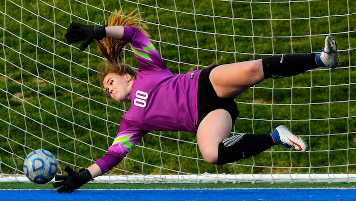 (Steve Griffin | The Salt Lake Tribune) East goal keeper Katie Liljenquest dives for a penalty kick during shootout against Maple Mountain during East's 5A semifinal girl's soccer match at Juan Diego High School in Draper Tuesday October 17, 2017.