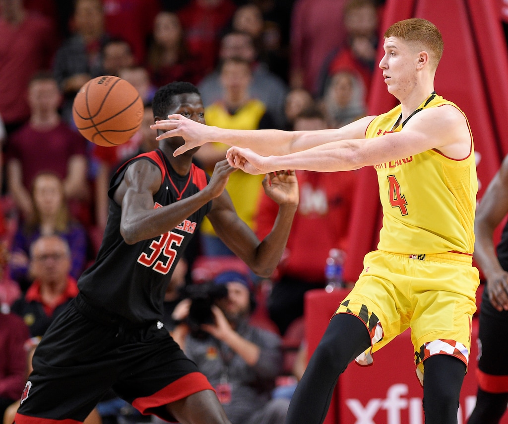 Maryland guard Kevin Huerter (4) passes the ball past Rutgers guard Issa Thiam (35) during the first half of an NCAA college basketball game Saturday, Feb. 17, 2018, in College Park, Md. (AP Photo/Nick Wass)