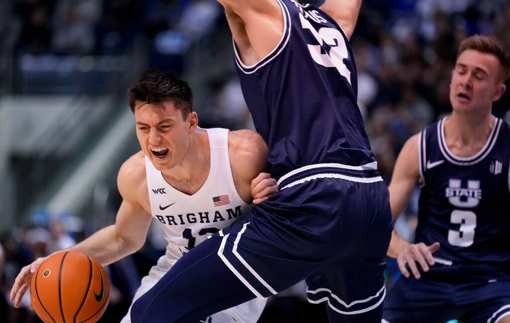 (Francisco Kjolseth | The Salt Lake Tribune)Brigham Young Cougars guard Alex Barcello (13) tries to push past the defense in basketball action between the Brigham Young Cougars and the Utah State Aggies at the Marriott Center in Provo, Wednesday, Dec. 8, 2021.