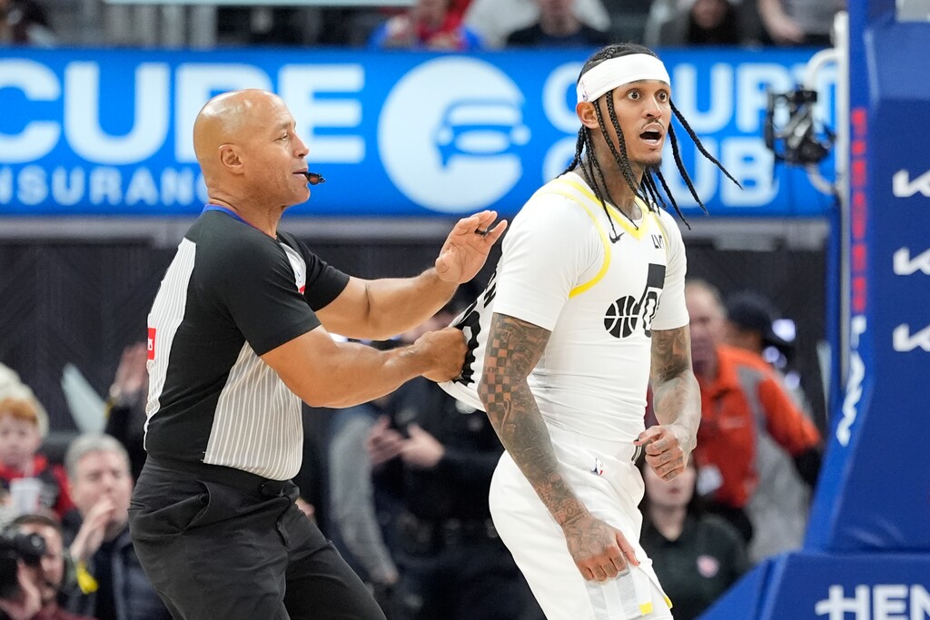 Utah Jazz guard Jordan Clarkson (00) gets into a stance with Detroit Pistons forward Ronald Holland II during the second half of an NBA basketball game, Thursday, Dec. 19, 2024, in Detroit. Both Clarkson and Holland were ejected. (AP Photo/Carlos Osorio)