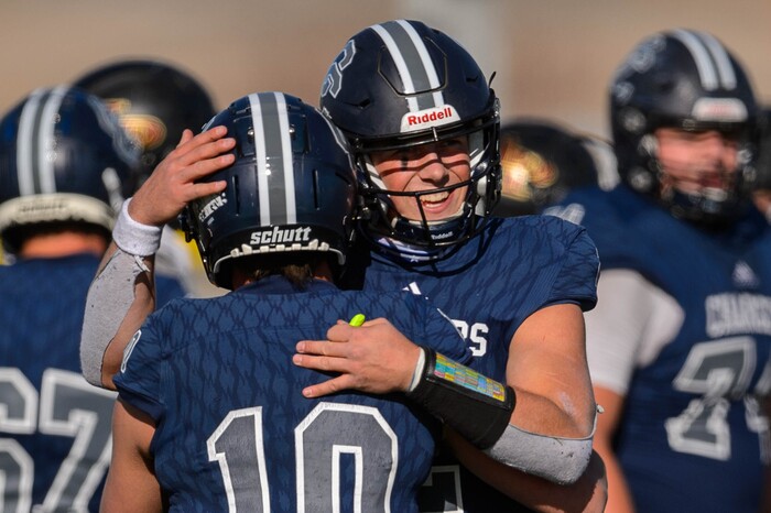 (Trent Nelson  |  The Salt Lake Tribune) Corner Canyon's Jaxson Dart embraces Austin Bell (10) at the end of the 6A state football championship game against Lone Peak at Cedar Valley High School in Eagle Mountain on Friday, Nov. 20, 2020.
