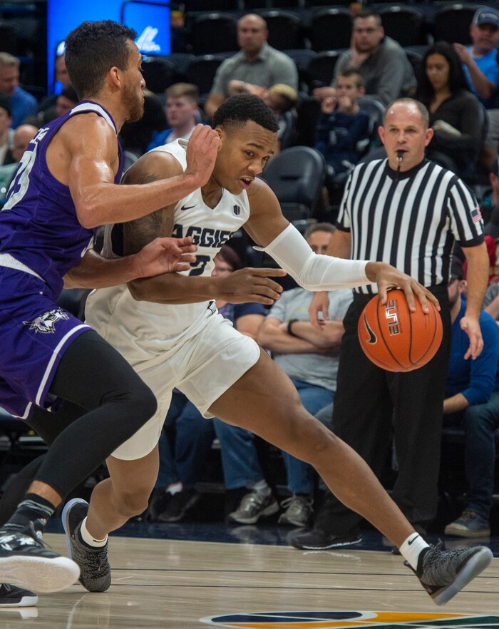(Rick Egan  |  The Salt Lake Tribune)      Utah State Aggies forward Dwayne Brown Jr. (2) drives with the ball, as Weber State Wildcats forward Brekkott Chapman (23) defends, in the Beehive Classic, between against the Utah State Aggies and Weber State Wildcats, a the Vivint Smart Home Arena, Saturday December 8, 2018.

 