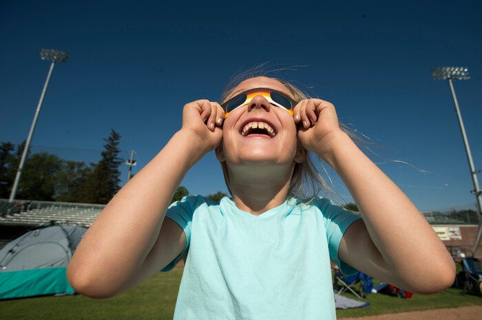 (Rick Egan  |  The Salt Lake Tribune)   Grace Gannon, 8, Idaho Falls, tests out her solar glasses, as she waits for the solar eclipse at Melaleuca Baseball Park, in Idaho Falls, Monday, August 21, 2017.


