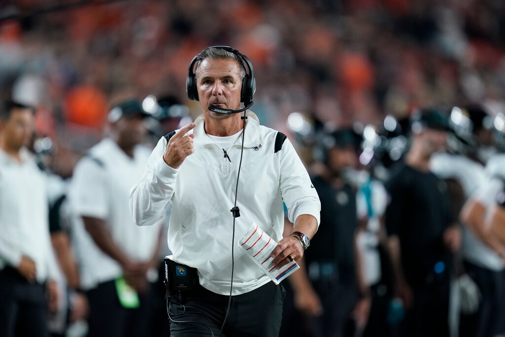 (Michael Conroy | AP) Jacksonville Jaguars head coach Urban Meyer walks with an official during the first half of an NFL football game against the Cincinnati Bengals, Thursday, Sept. 30, 2021, in Cincinnati.