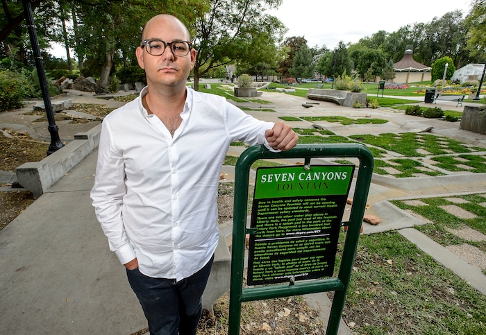 (Steve Griffin  |  The Salt Lake Tribune)  Sam Goldsmith at the closed Seven Canyons Fountain at Liberty Park in Salt Lake City Thursday September 14, 2017. The fountain was closed this year for health concerns could be brought up to code and reopened for far less than the $2 million quoted by Salt Lake City, according to Sam Goldsmith, the son of Seven Canyons Fountain artist Steven Goldsmith. Sam Goldsmith dug through city documents and even enlisted a local architecture firm to create an alternative proposal that he presented in a Liberty Wells Community Council meeting Thursday.  
