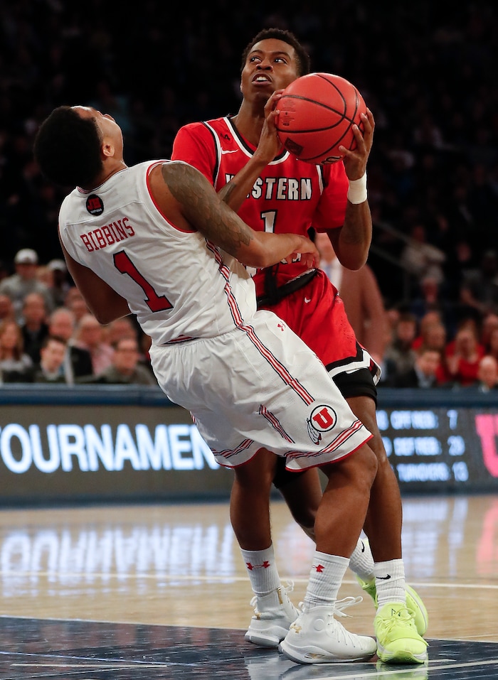 Utah guard Justin Bibbins, left, draws an offensive foul on Western Kentucky guard Lamonte Bearden during the second half of an NCAA college basketball game in the semifinals of the NIT, Tuesday, March 27, 2018, in New York. Utah won 69-64. (AP Photo/Julie Jacobson)
