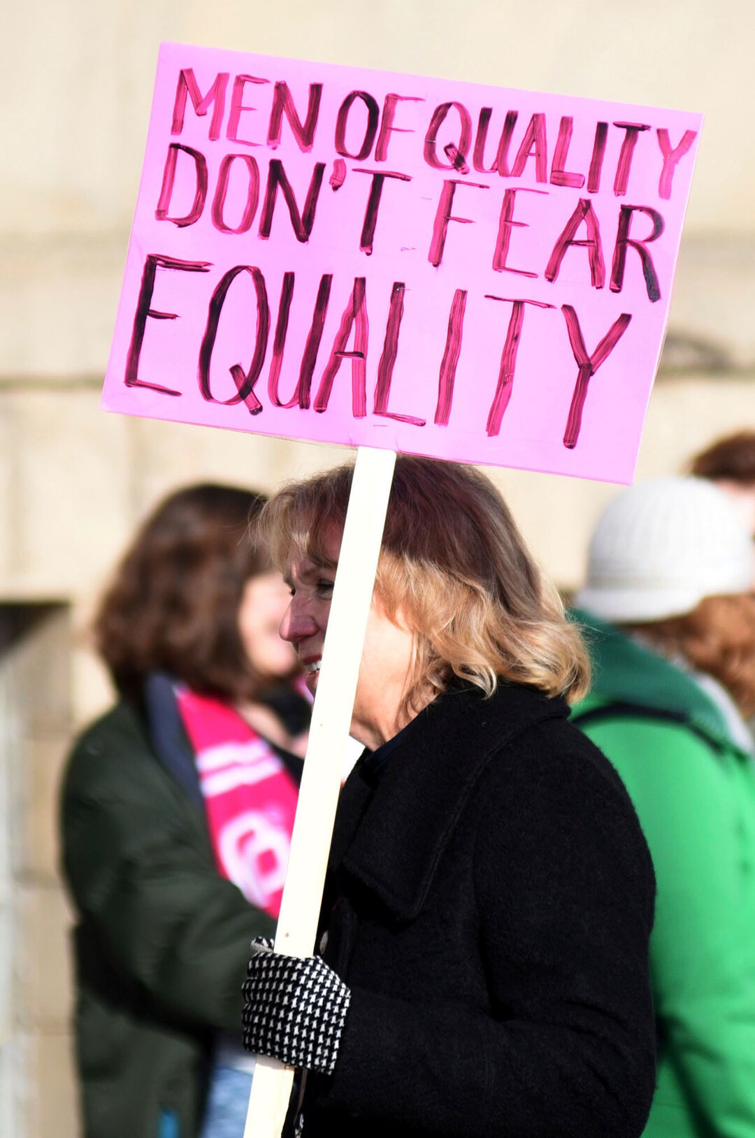 An unidentified woman joins hundreds of others Saturday, Jan. 20, 2018 for a march through downtown Eau Claire, Wis. as part of the Women's March Wisconsin Day of Action. The event followed a rally at Phoenix Park and was a companion to marches in Milwaukee and Green Bay. (Elena Dawson/The Eau Claire Leader-Telegram via AP)