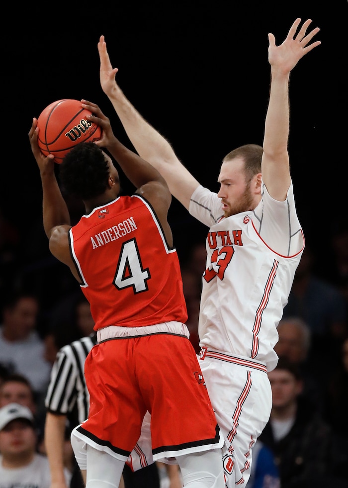 Western Kentucky guard Josh Anderson (4) shoots against Utah forward David Collette (13) during the first half of an NCAA college basketball game in the semifinals of the NIT, Tuesday, March 27, 2018, in New York. (AP Photo/Julie Jacobson)