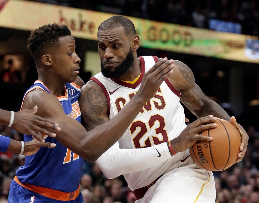 Cleveland Cavaliers' LeBron James, right, drives past New York Knicks' Frank Ntilikina, from France, in the first half of an NBA basketball game, Sunday, Oct. 29, 2017, in Cleveland. (AP Photo/Tony Dejak)